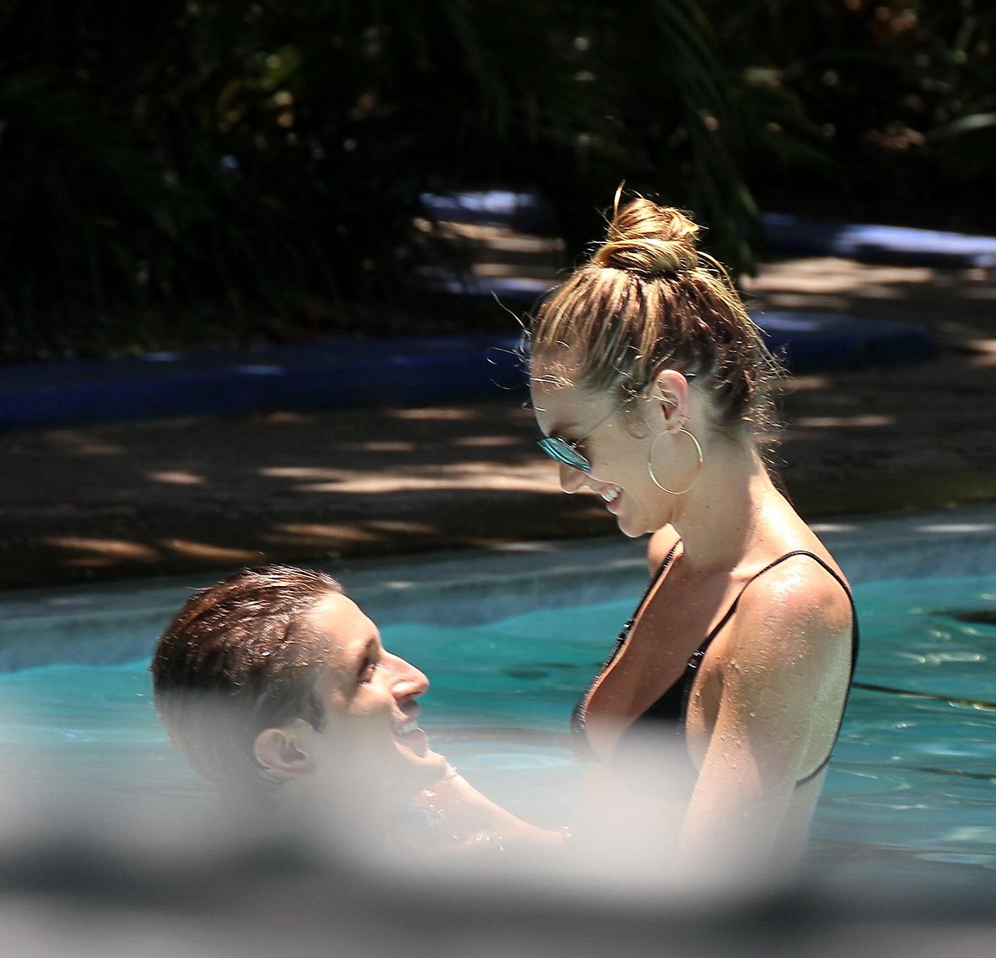 6P Candice Swanepoel in sexy black bikini petting with her boyfriend at the pool in