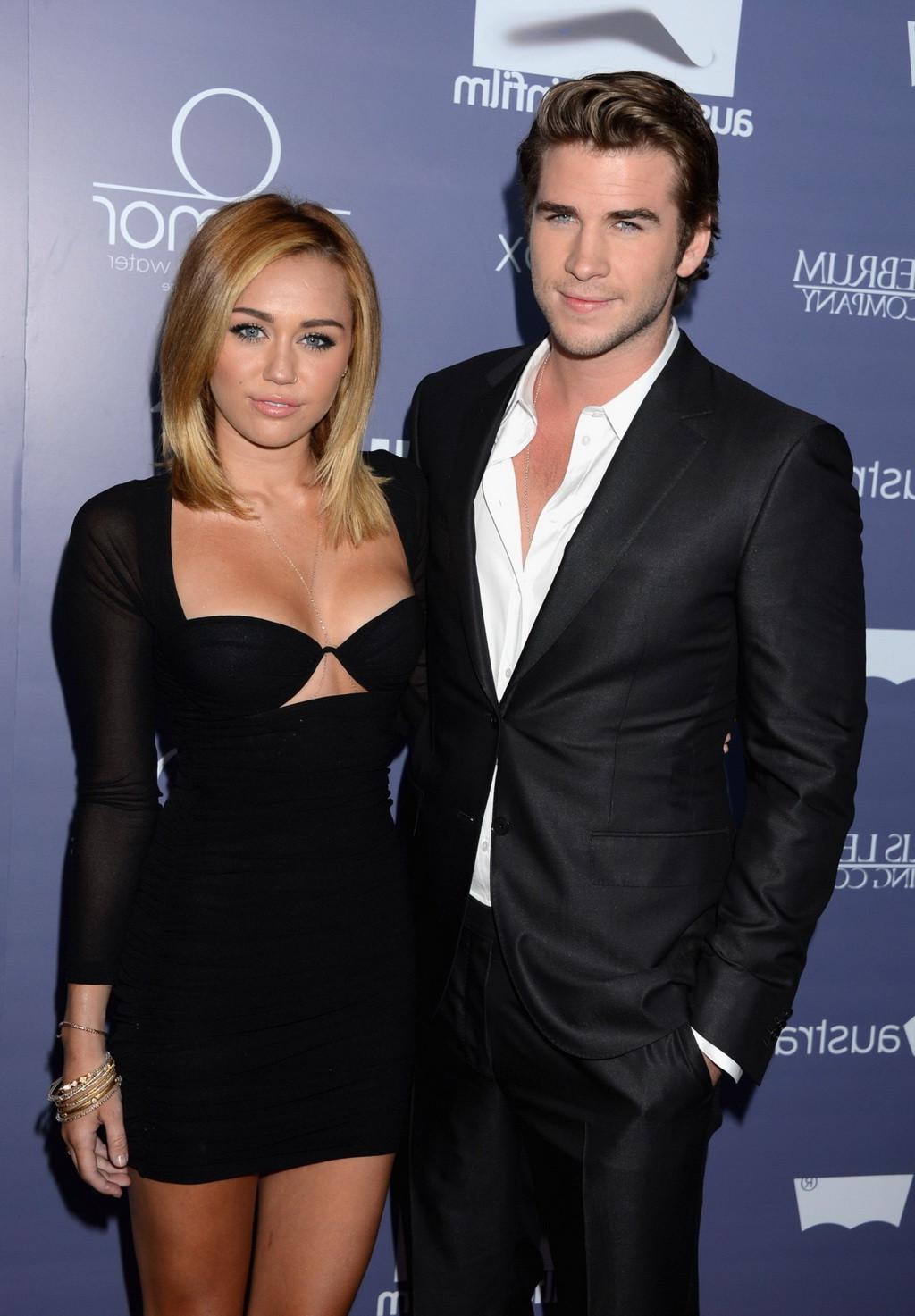 10P Miley Cyrus showing her hot boobs in bra wearing wide open low cut mini dress at