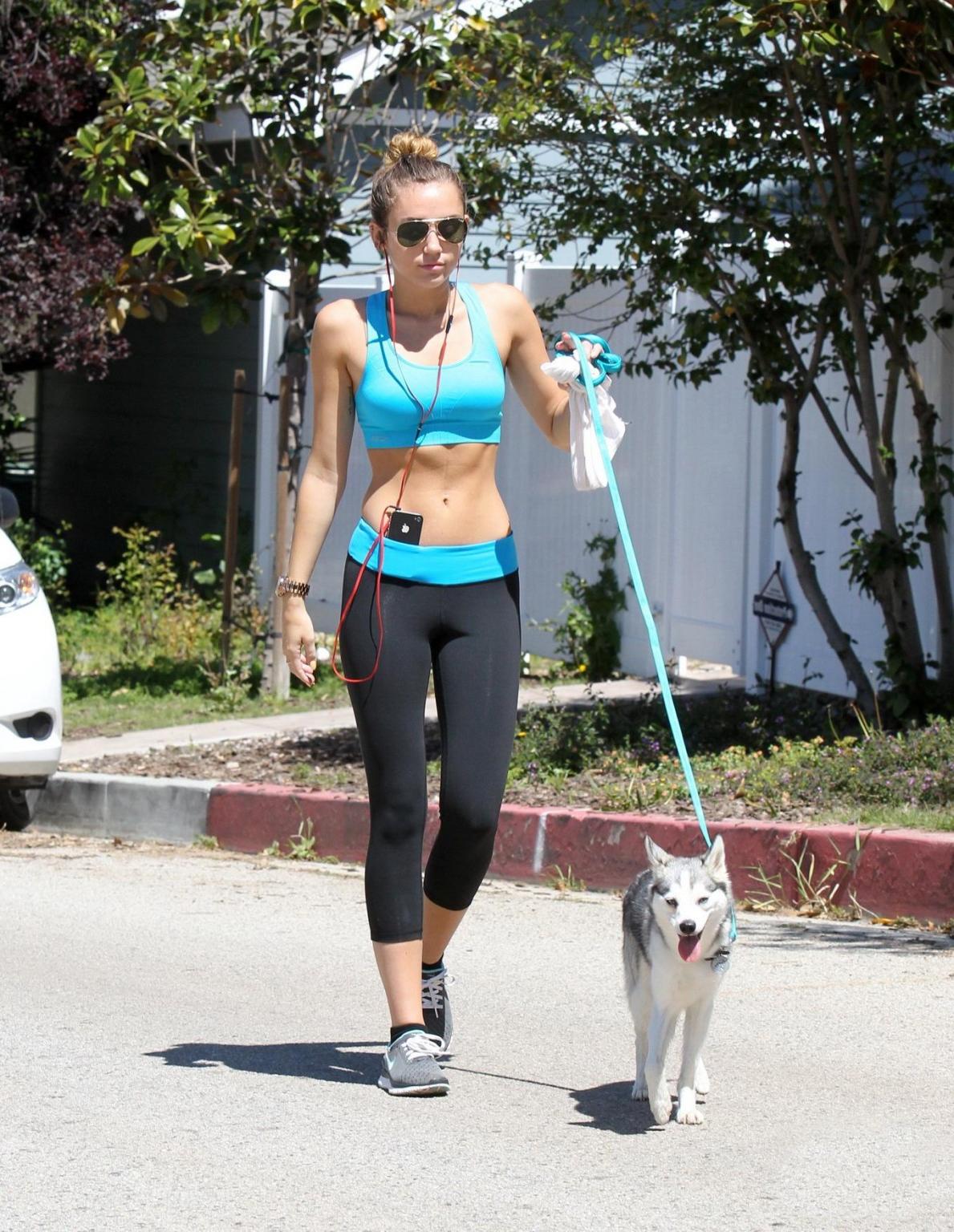 9P Miley Cyrus shows off her ass wearing sports bra  tights for a jog in LA