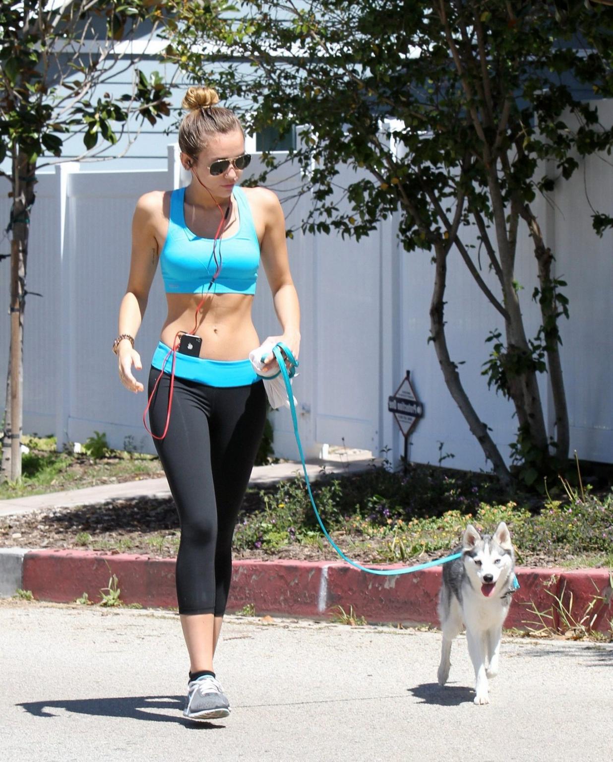 9P Miley Cyrus shows off her ass wearing sports bra  tights for a jog in LA
