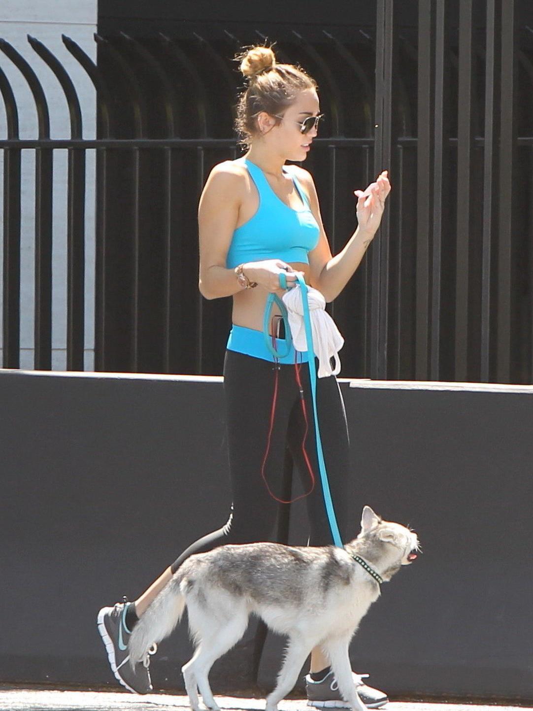 9P Miley Cyrus shows off her ass wearing sports bra  tights for a jog in LA