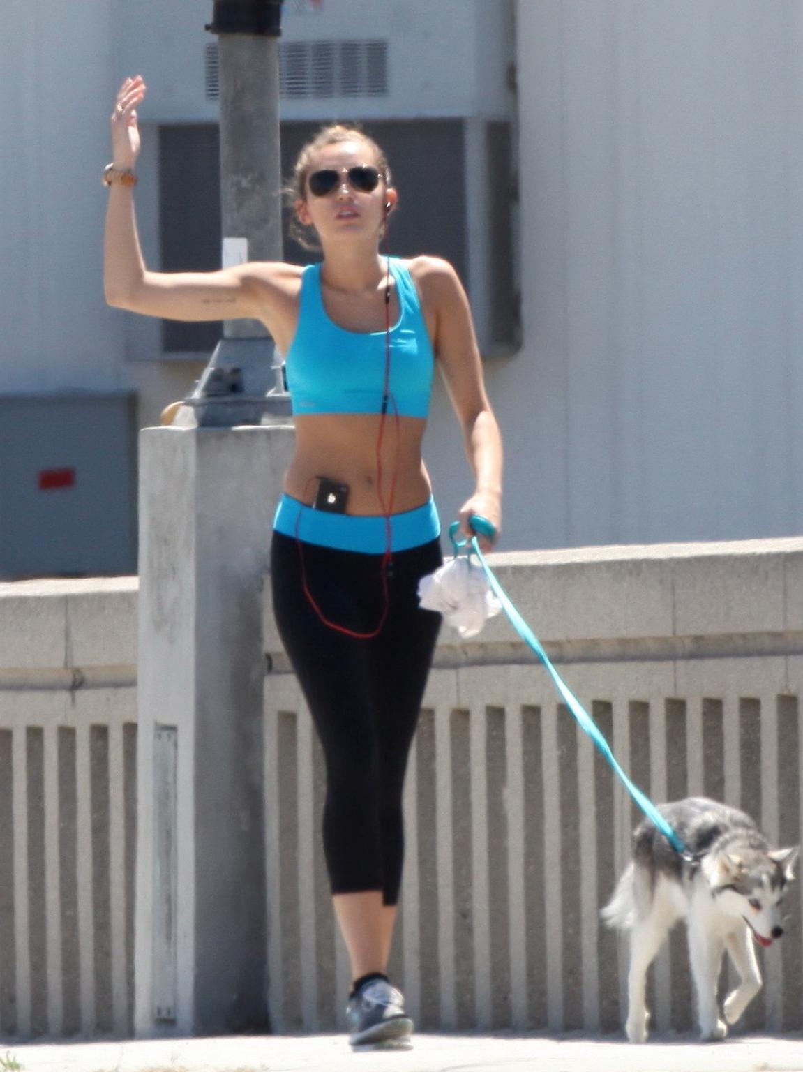 9P Miley Cyrus shows off her ass wearing sports bra  tights for a jog in LA