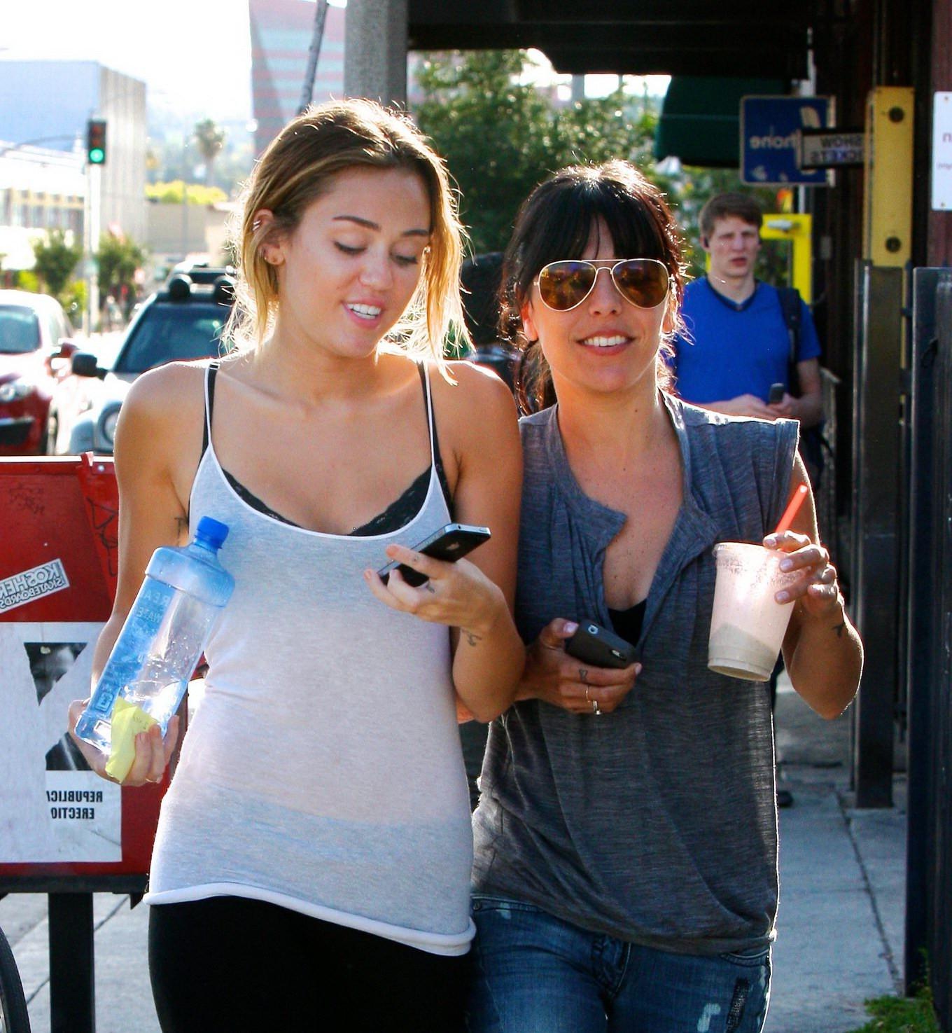 16P Miley Cyrus see-through to bra leaving a pilates class in LA