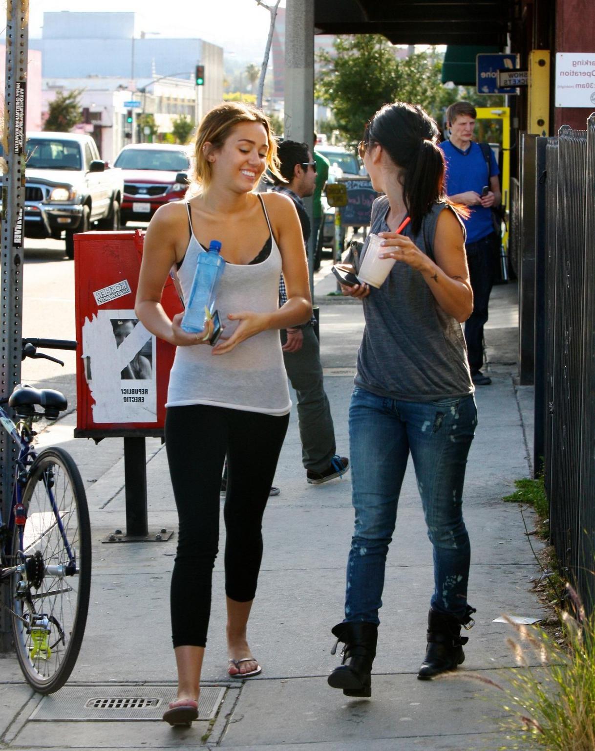 16P Miley Cyrus see-through to bra leaving a pilates class in LA