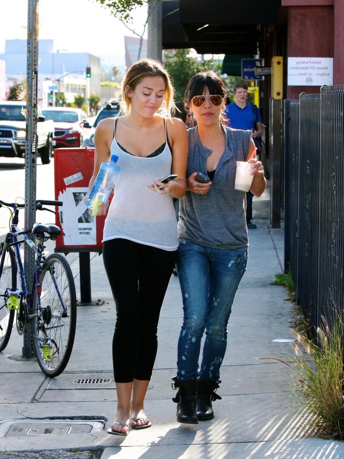 16P Miley Cyrus see-through to bra leaving a pilates class in LA