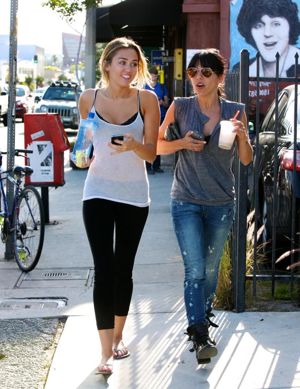16P Miley Cyrus see-through to bra leaving a pilates class in LA