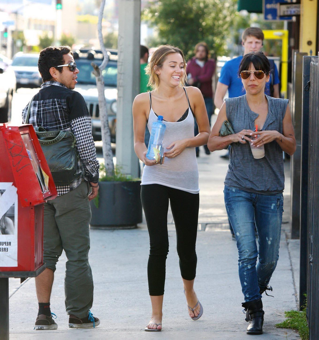 16P Miley Cyrus see-through to bra leaving a pilates class in LA