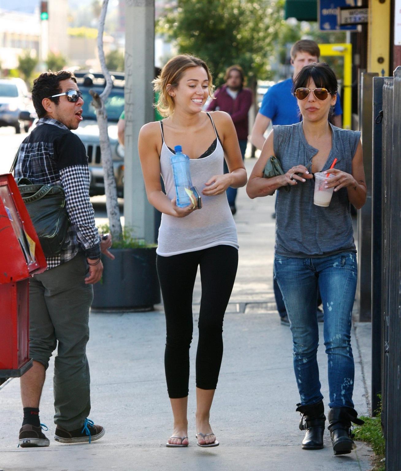 16P Miley Cyrus see-through to bra leaving a pilates class in LA