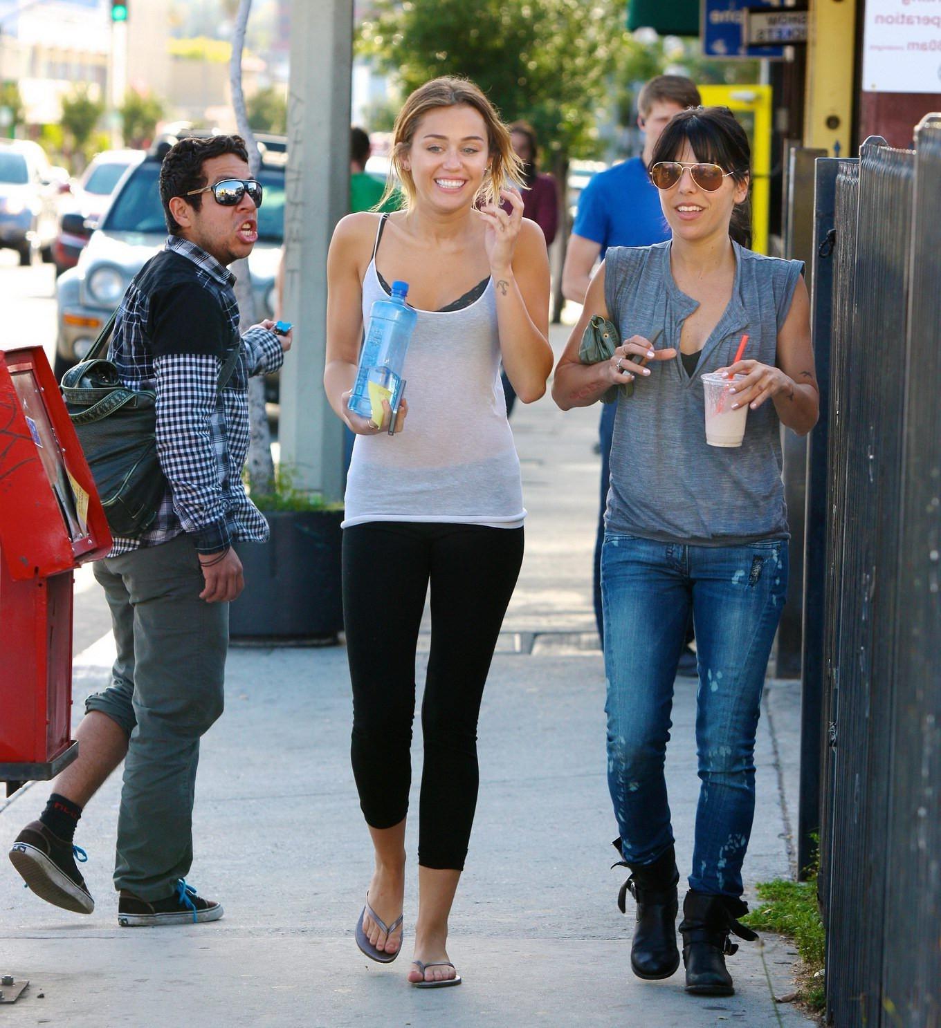 16P Miley Cyrus see-through to bra leaving a pilates class in LA