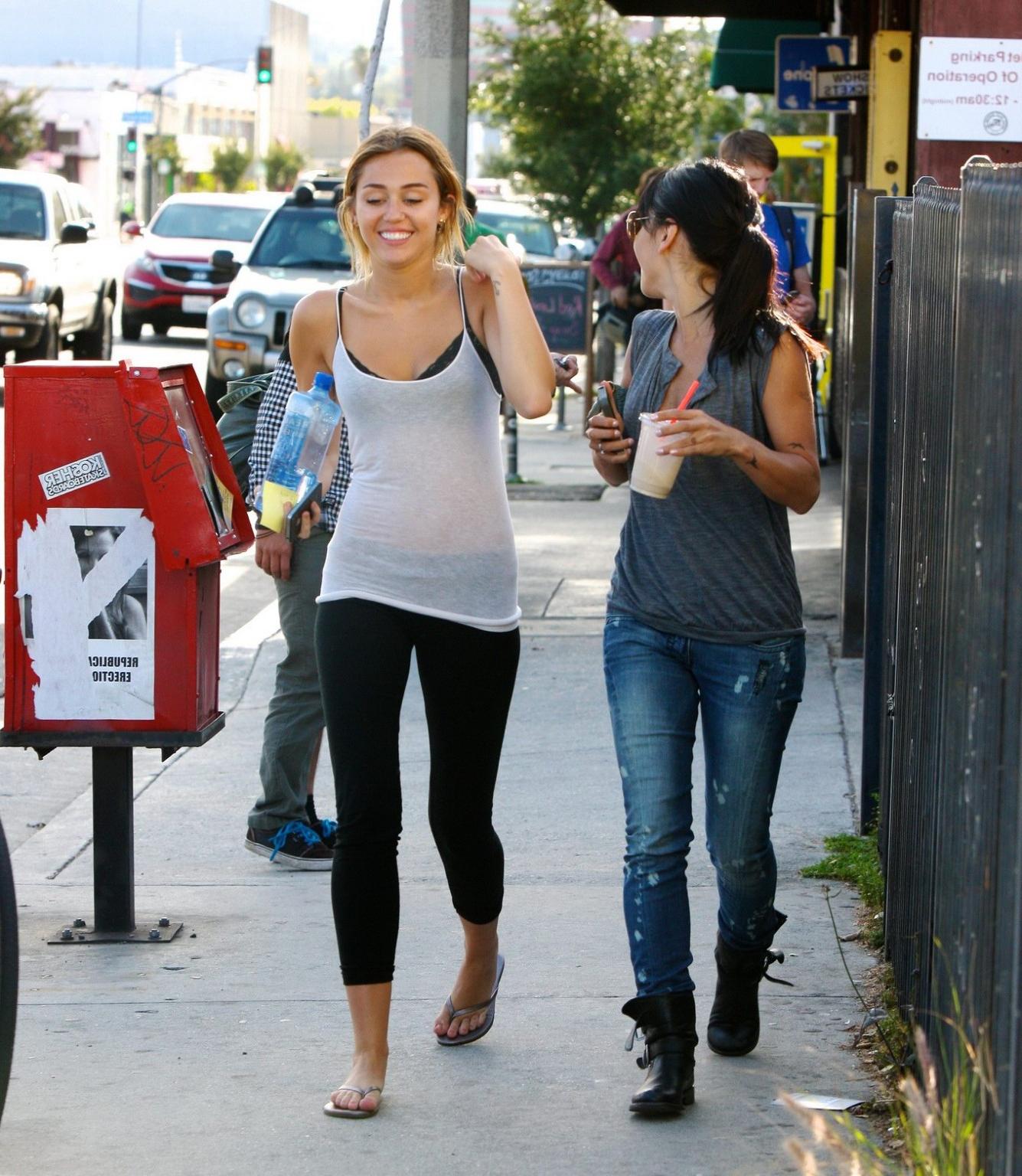 16P Miley Cyrus see-through to bra leaving a pilates class in LA