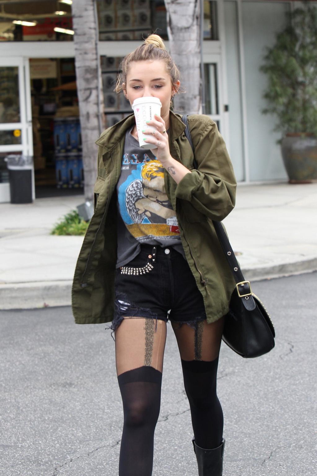 16P Miley Cyrus leggy wearing stockings  biker boots outside Starbucks in Hollywood