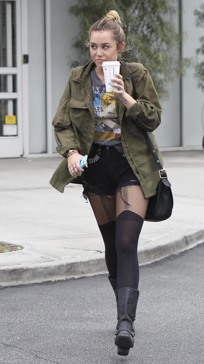 16P Miley Cyrus leggy wearing stockings  biker boots outside Starbucks in Hollywood