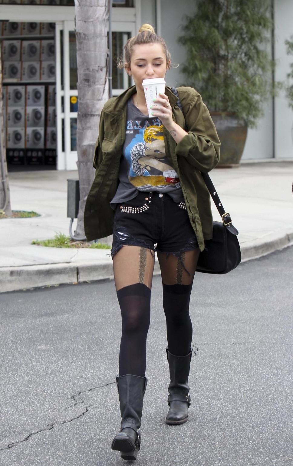 16P Miley Cyrus leggy wearing stockings  biker boots outside Starbucks in Hollywood