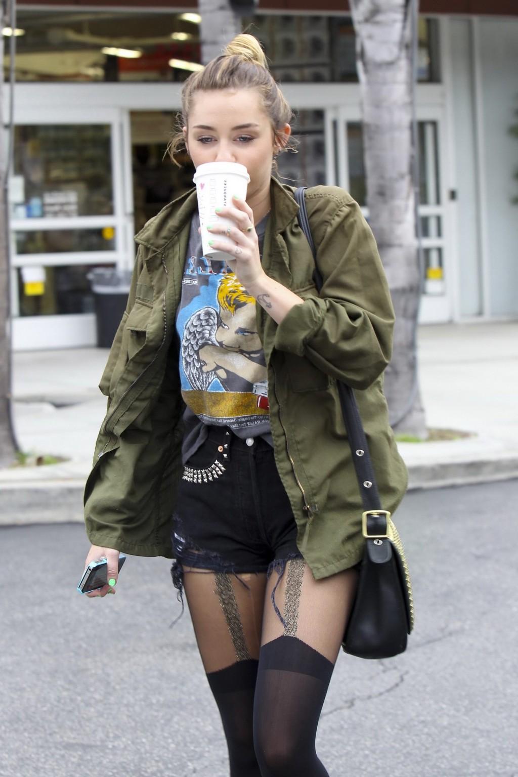 16P Miley Cyrus leggy wearing stockings  biker boots outside Starbucks in Hollywood