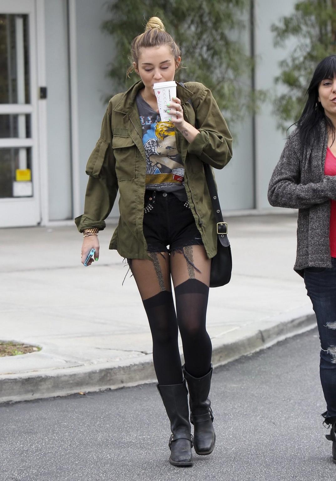 16P Miley Cyrus leggy wearing stockings  biker boots outside Starbucks in Hollywood