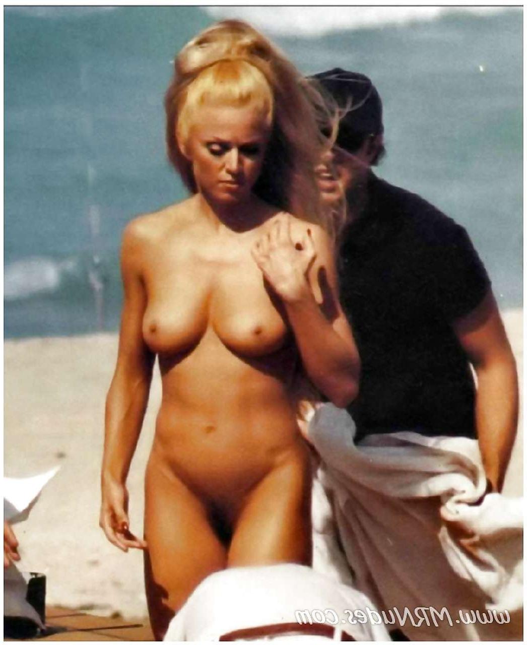 16P Madonna showing her tits in see thru bra and pubic hair on beach paparazzi pictu