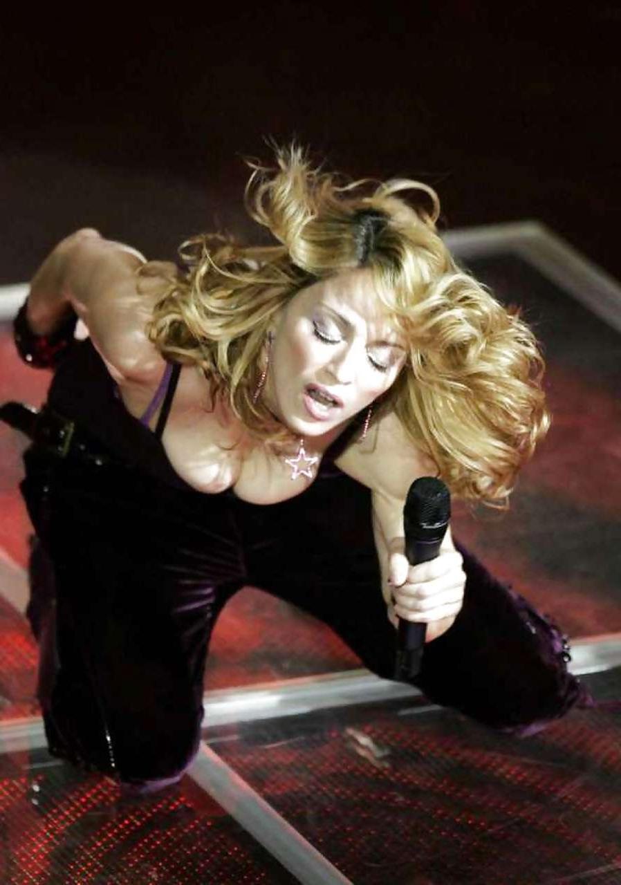 16P Madonna showing her tits in see thru bra and pubic hair on beach paparazzi pictu