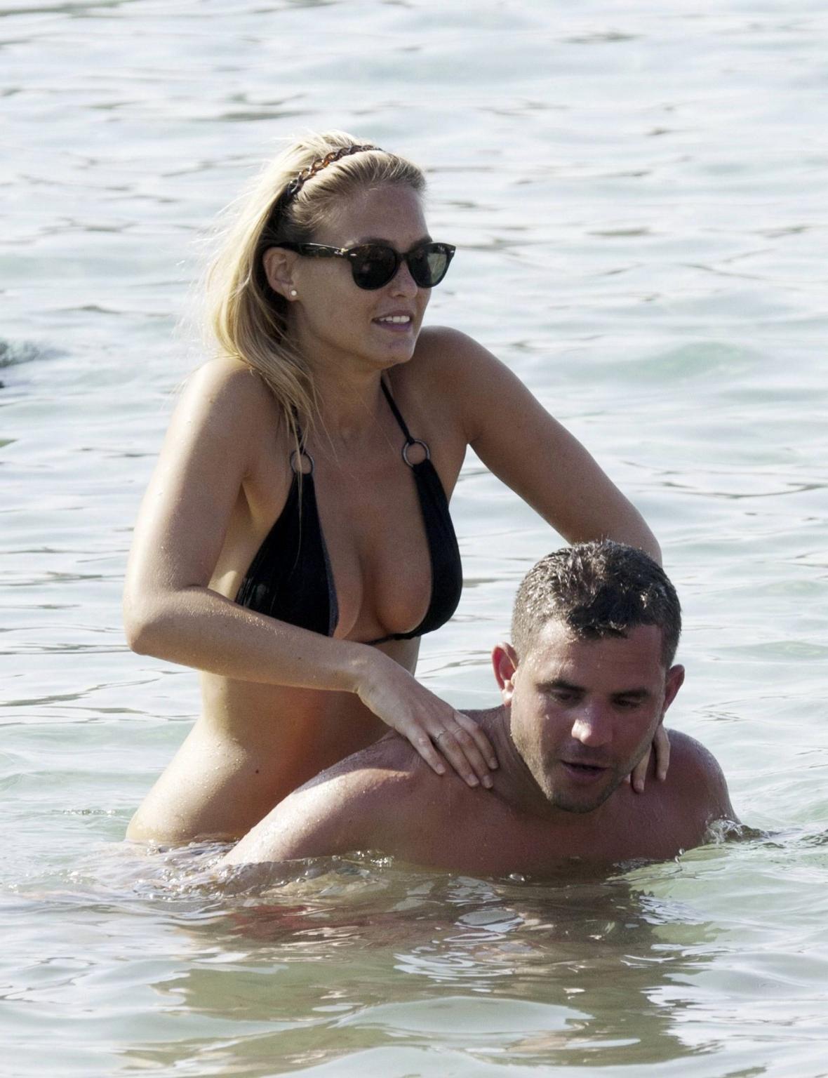 16P Bar Refaeli busty wearing black bikini on a beach in Greece
