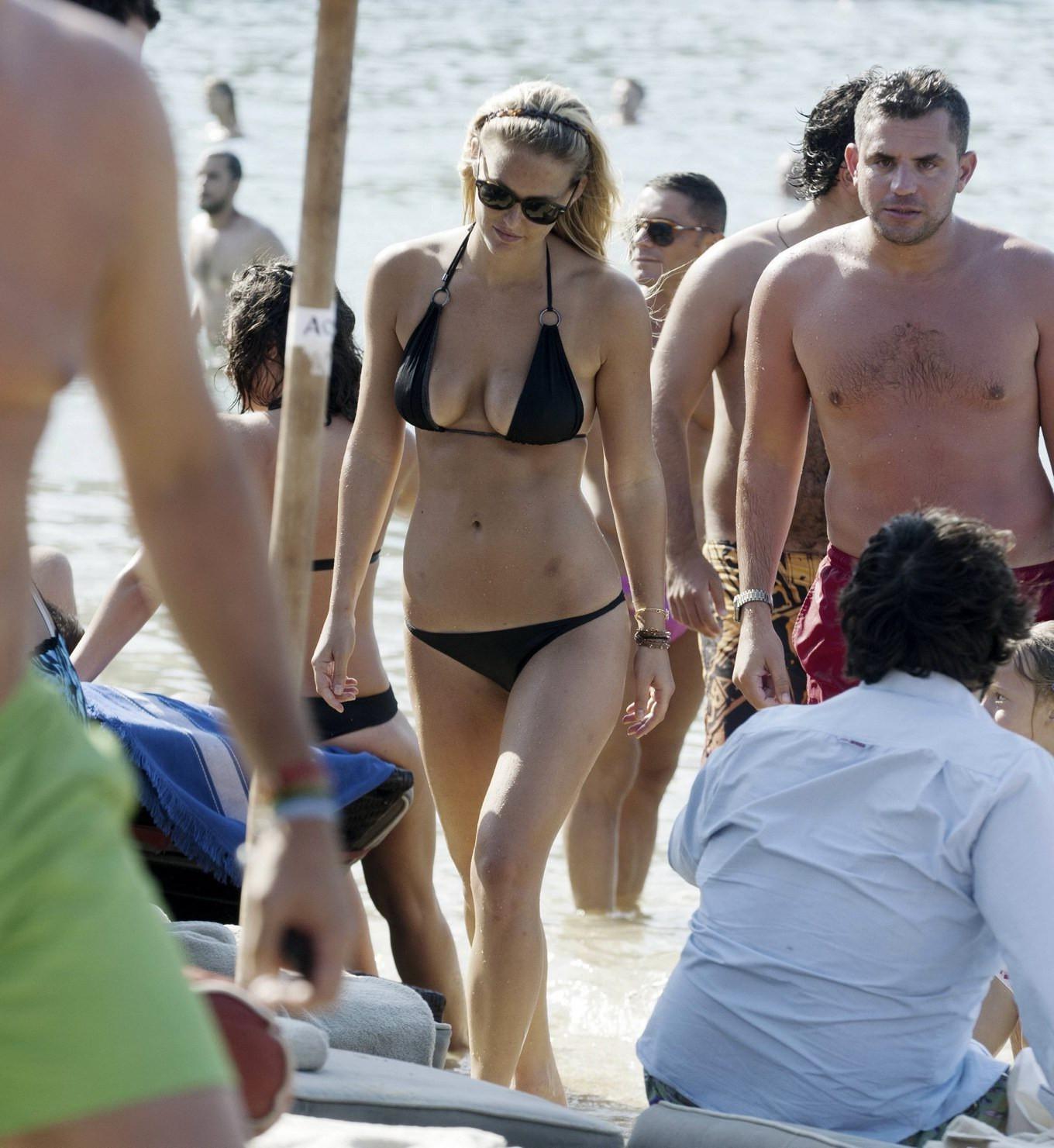 16P Bar Refaeli busty wearing black bikini on a beach in Greece