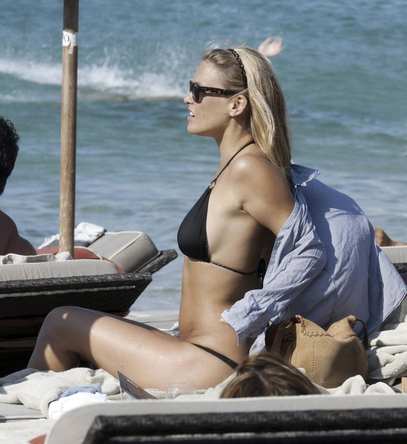 16P Bar Refaeli busty wearing black bikini on a beach in Greece
