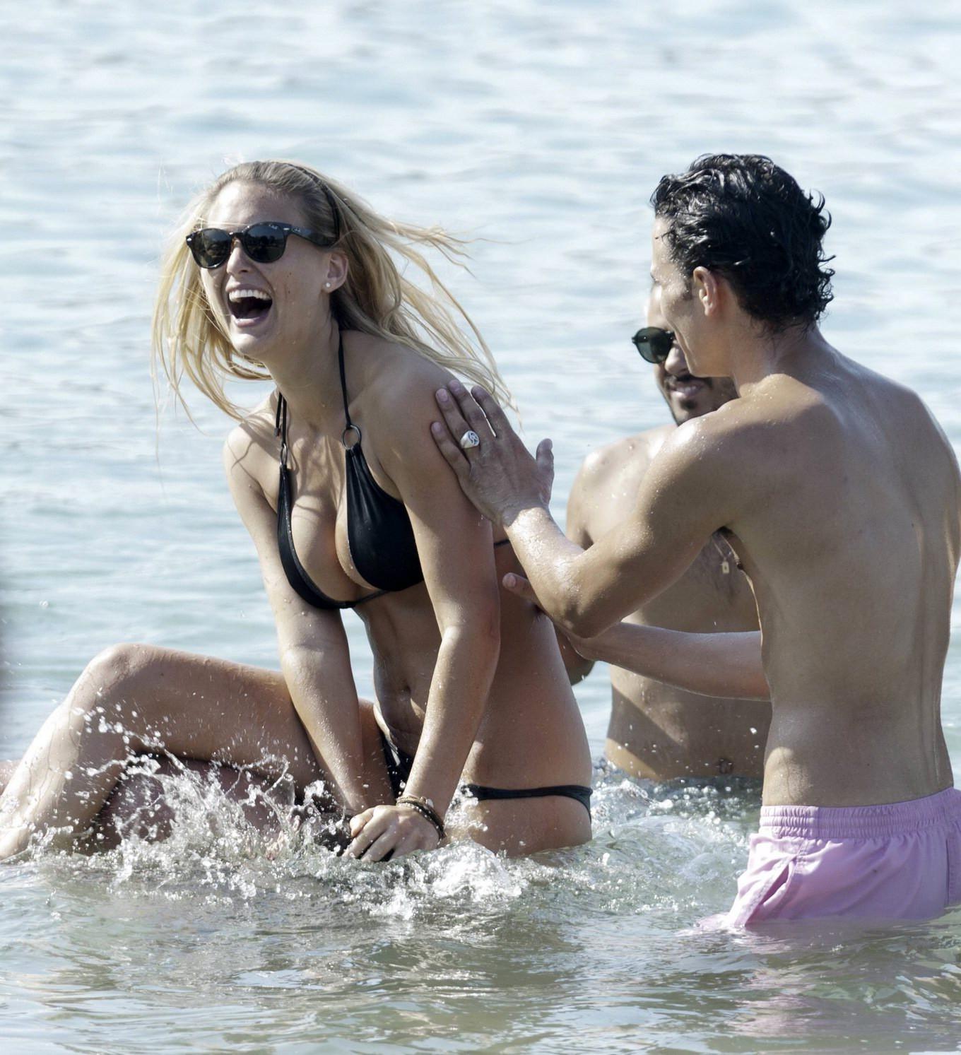16P Bar Refaeli busty wearing black bikini on a beach in Greece