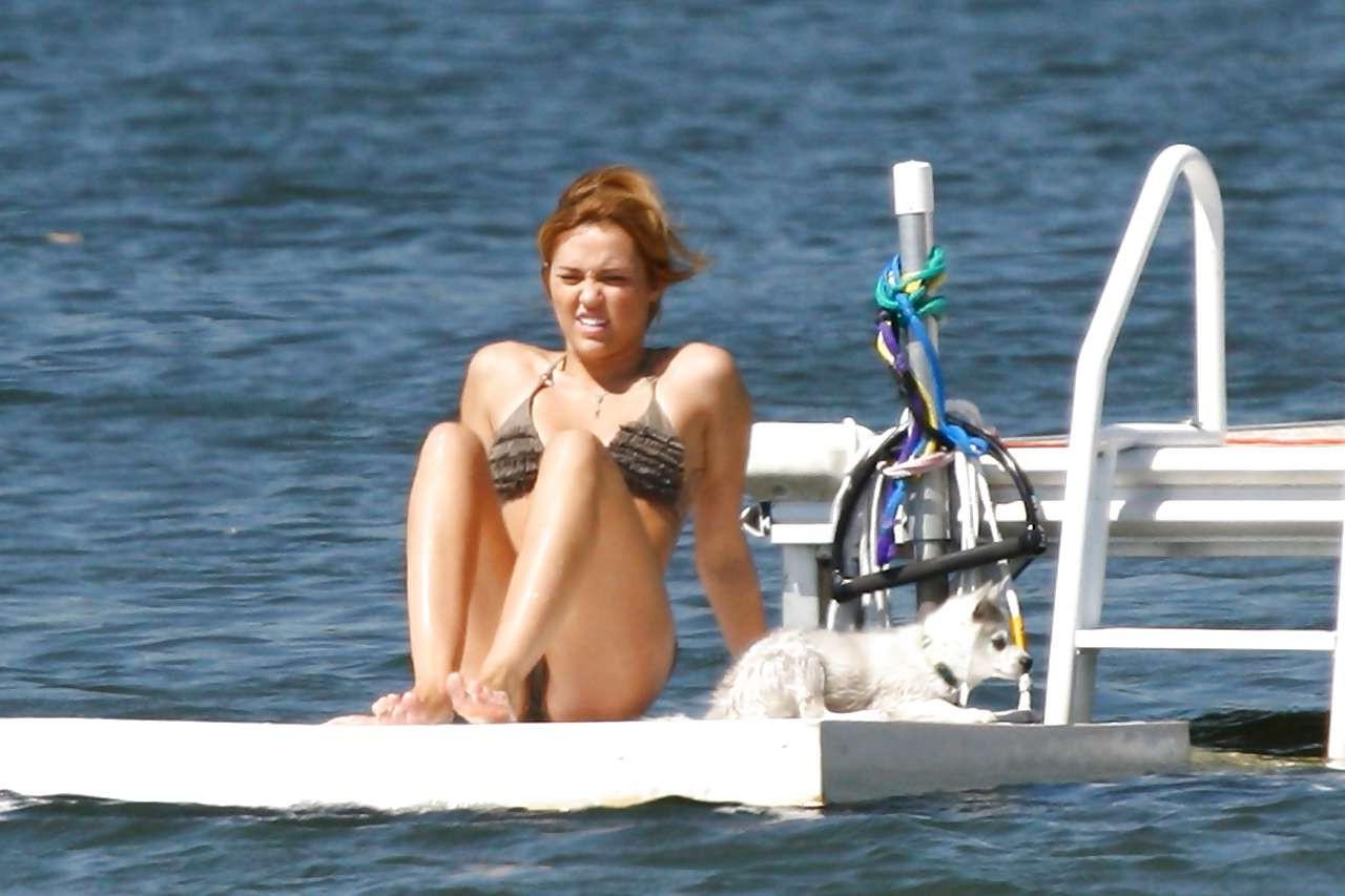 16P Miley Cyrus posing without bra and looking very sexy in bikini paparazzi picture