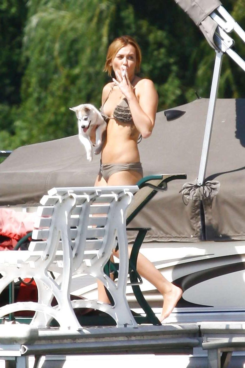16P Miley Cyrus posing without bra and looking very sexy in bikini paparazzi picture
