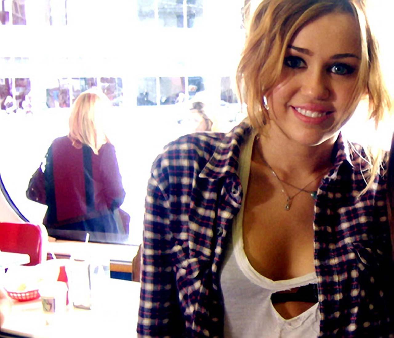 16P Miley Cyrus exposing her sexy body and nice tits in black bra