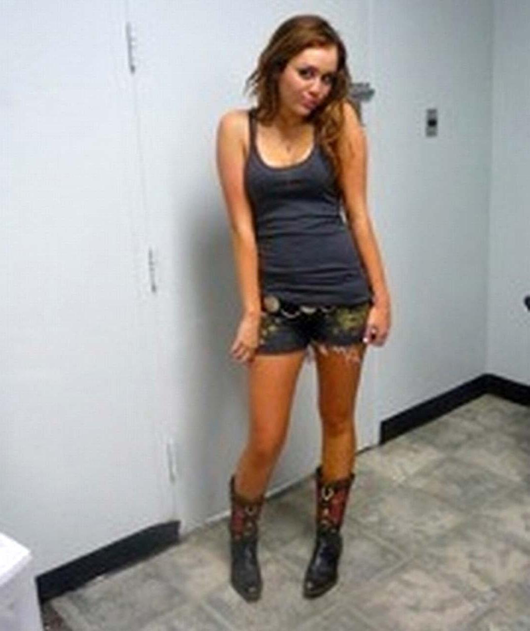 16P Miley Cyrus exposing her sexy body and nice tits in black bra