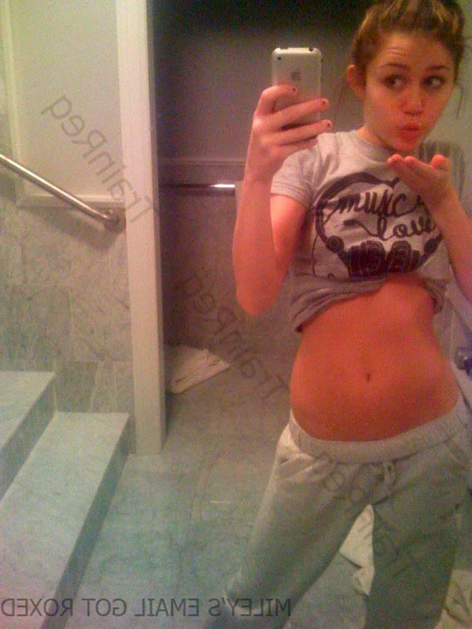 16P Miley Cyrus exposing her sexy body and nice tits in black bra