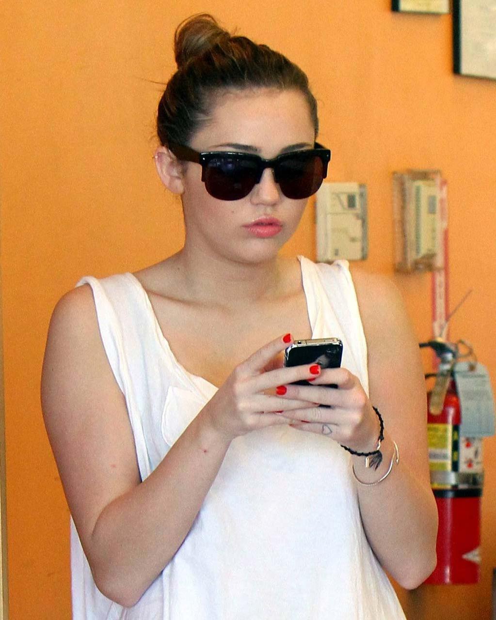 10P Miley Cyrus flashing her see thru bra in some sexy paparazzi pictures