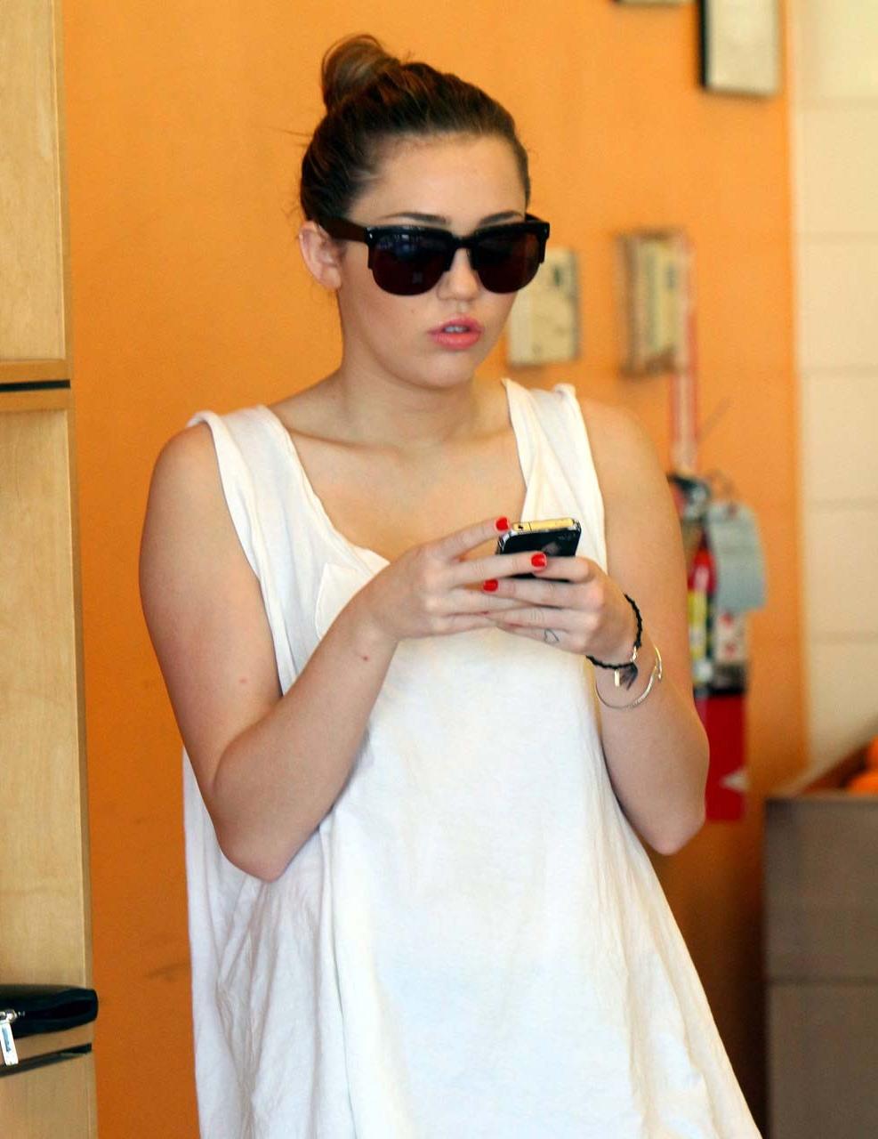 10P Miley Cyrus flashing her see thru bra in some sexy paparazzi pictures