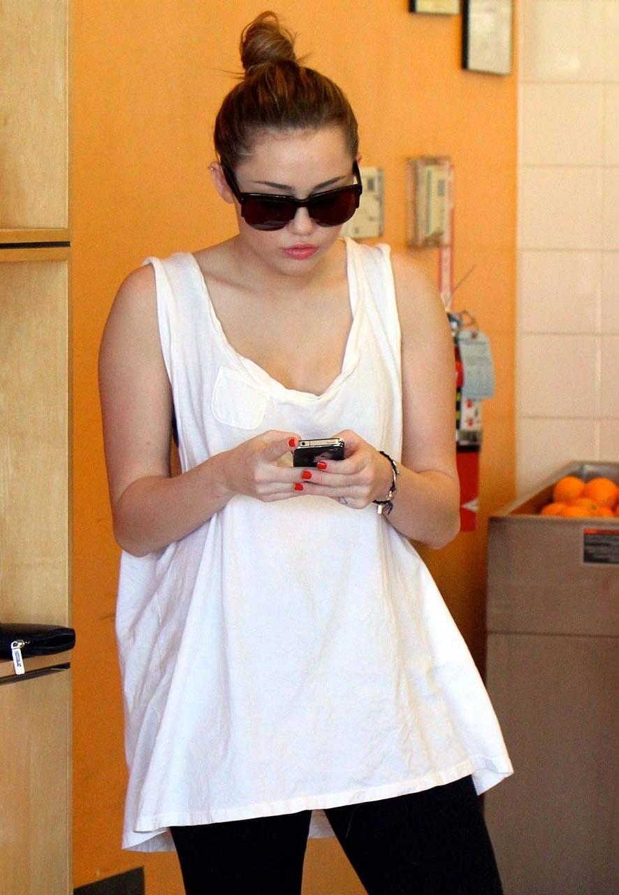 10P Miley Cyrus flashing her see thru bra in some sexy paparazzi pictures