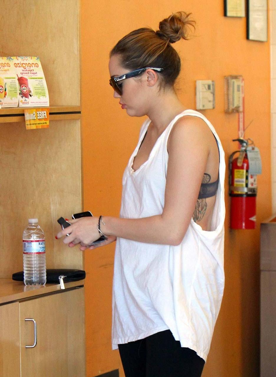 10P Miley Cyrus flashing her see thru bra in some sexy paparazzi pictures