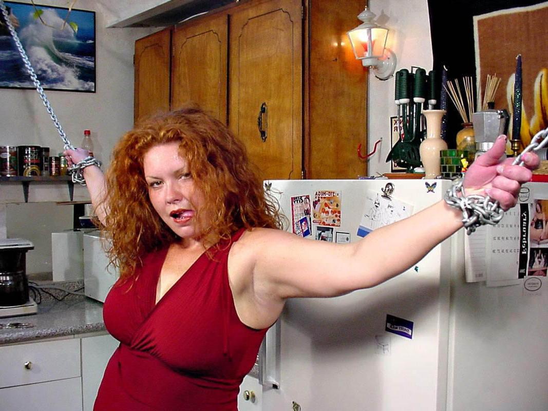 15P Stunning chained busty fat redhead