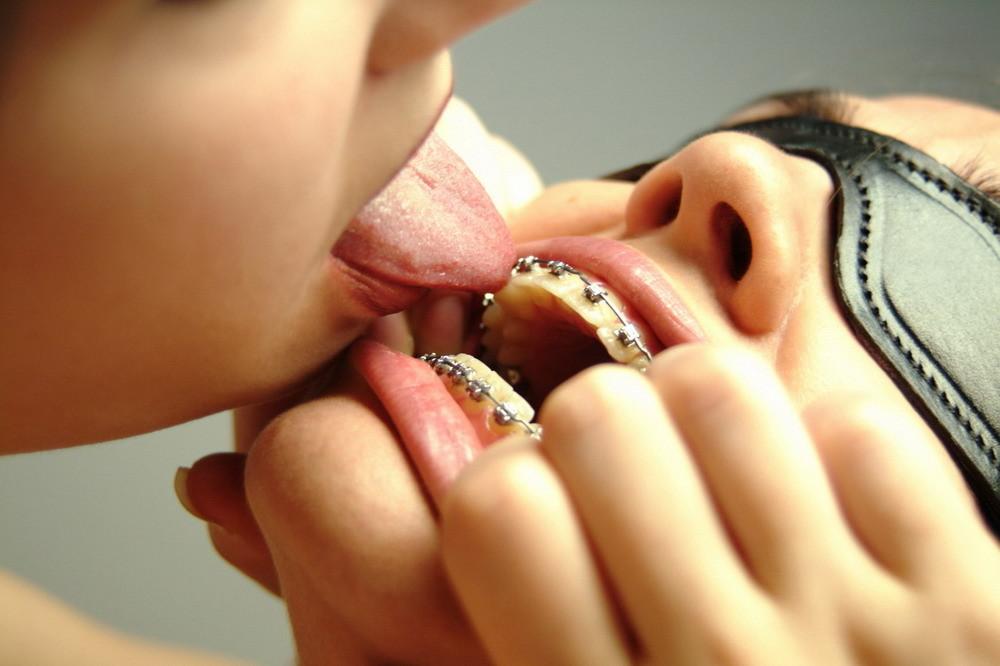 16P Dominatrix with a dildo plays with a pigtailed teen in braces