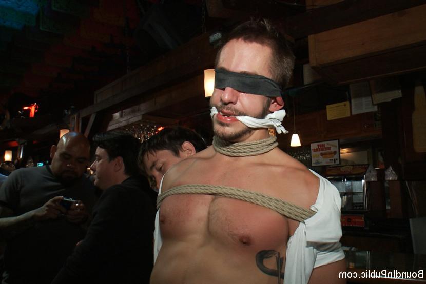 15P Bryan Cole gets spanked, humiliated and used in a crowded public bar.