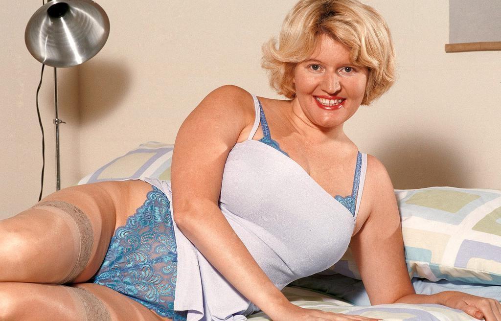 20P Busty blonde milf in bed strip teasing in sexy stockings