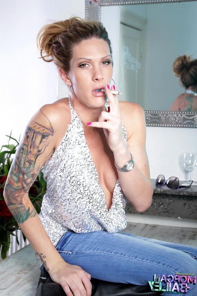 12P Transsexual Morgan Bailey posing in long boots and jeans