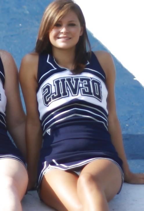 25P Cheerleader cuties with there legs wide apart. 