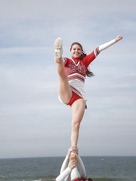 25P Cheerleader cuties with there legs wide apart. 