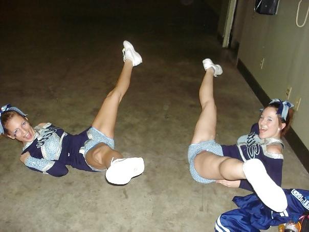 25P Cheerleader cuties with there legs wide apart. 