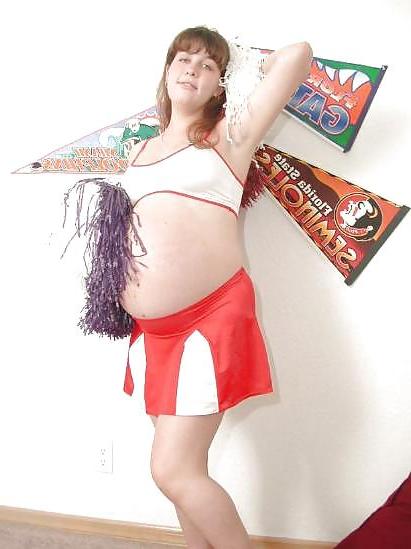25P Pregnant brunette cheerleader undressing
