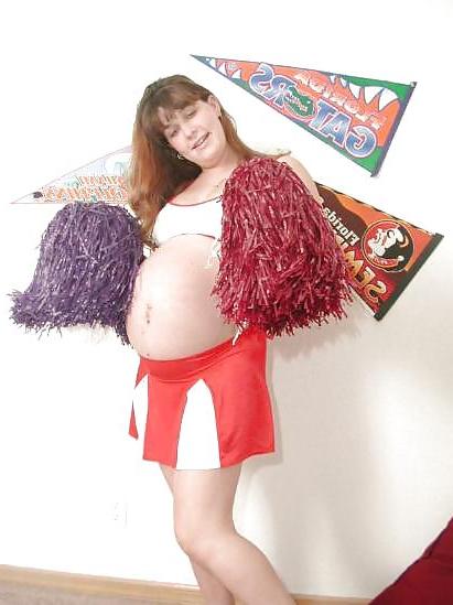 25P Pregnant brunette cheerleader undressing