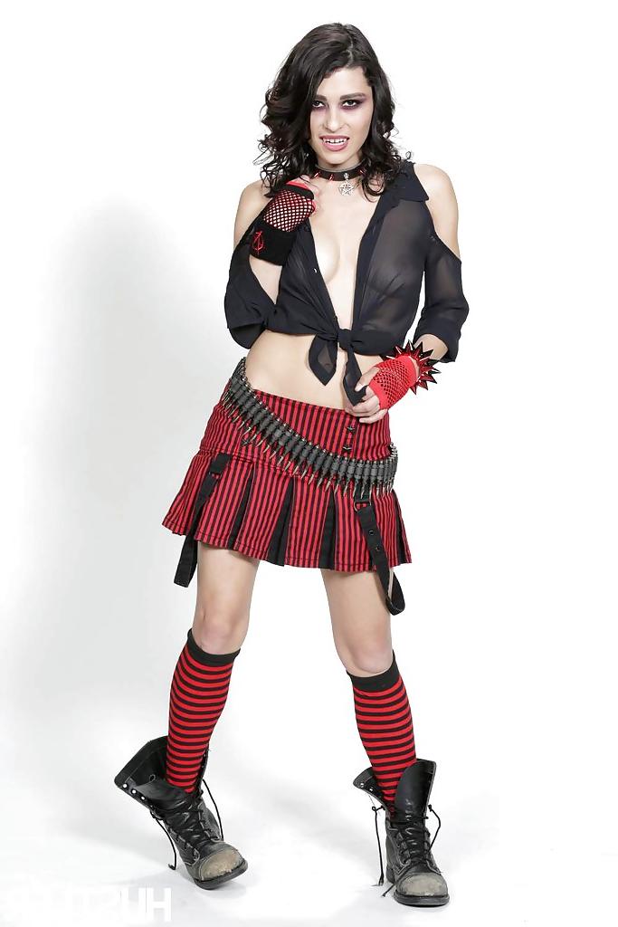 16P Outstanding brunette Raven Rockette is posing in her red skirt