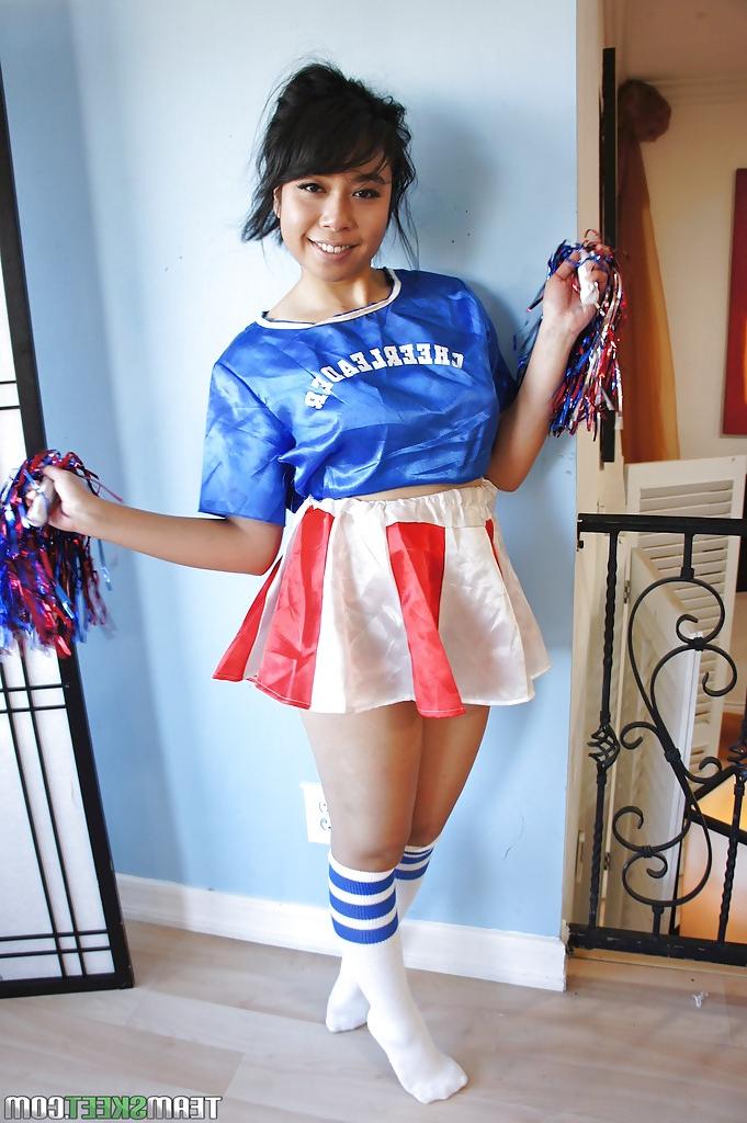 16P Petite Oriental cheerleader May Lee flashing black panties under skirt