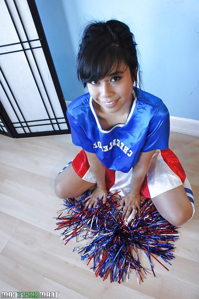 16P Petite Oriental cheerleader May Lee flashing black panties under skirt