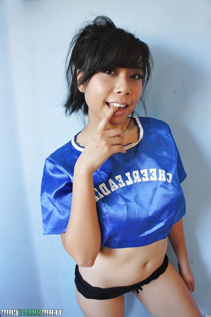 16P Petite Oriental cheerleader May Lee flashing black panties under skirt
