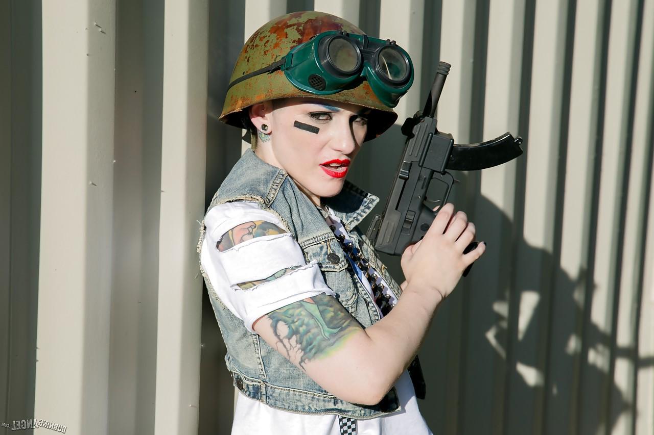 13P Tattooed chick with shaved head in army gear giving man in ape mask a BJ