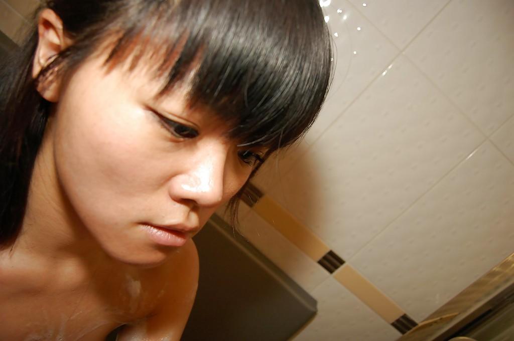 16P Asian cutie Midori Kimishima gives a sensual blowjob in the bathroom